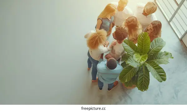 Top view of diverse business team joining hands in unity showing teamwork and motivation in office