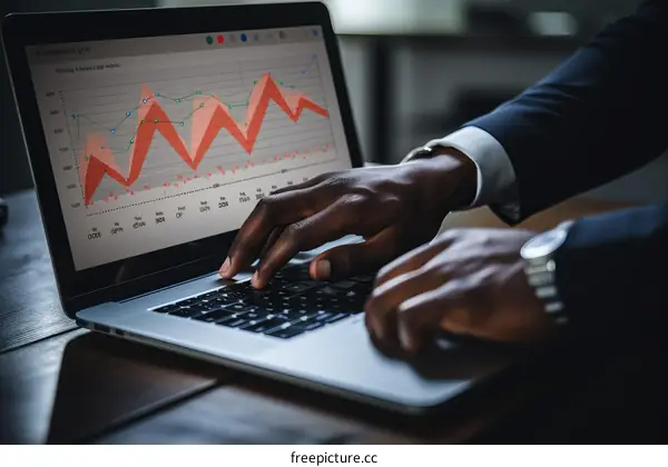 Black businessman analyzing financial data on laptop