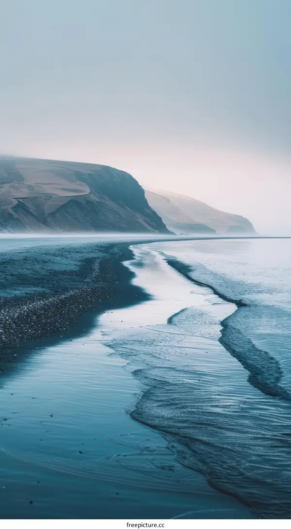 Black sand beach with large waves crashing on shore