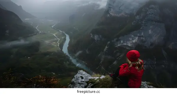 Woman in Red Jacket Gazes at Scenic Valley View