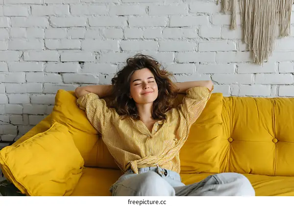 Relaxed woman on a yellow sofa