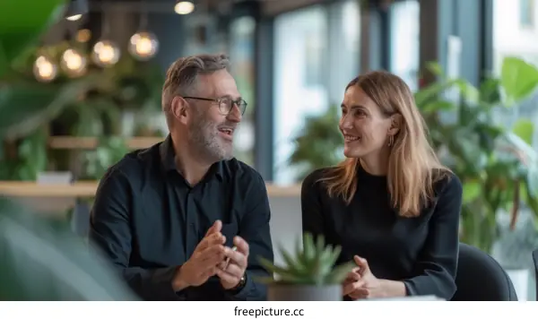 Business conversation between a man and a woman in a modern office
