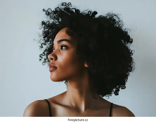Black Woman with Curly Hair Looking Away