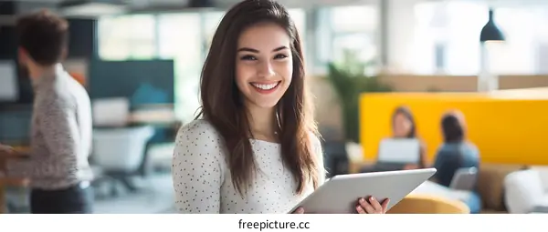 Smiling Woman Holding Tablet in Office Environment