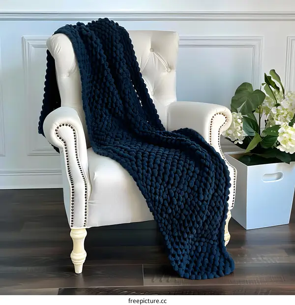 Soft Navy Blue Chunky Knit Blanket On White Chair