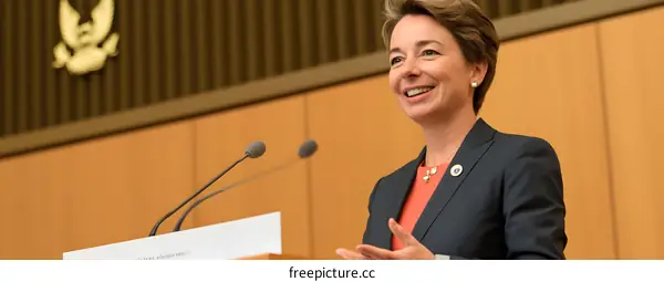 Woman Speaking at a Podium in a Conference Hall