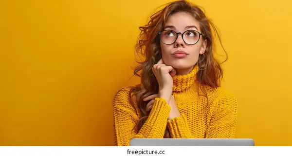 pensive young woman wearing glasses looking away