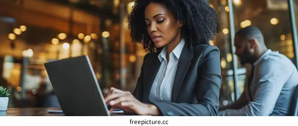 African American Woman Working on Laptop in Cafe