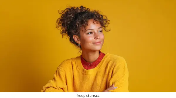 Smiling Woman in a Mustard Yellow Sweater Against a Vivid Yellow Background