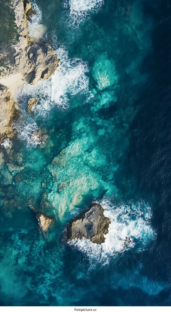 Aerial View of Ocean Waves Crashing on Rocks