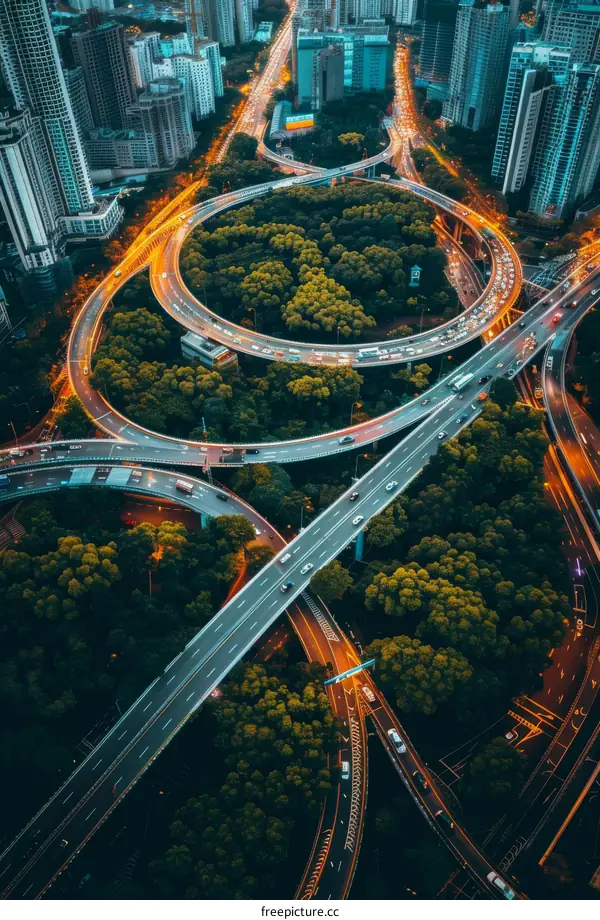 Aerial View of Urban Highway Interchange with Roundabout at Night