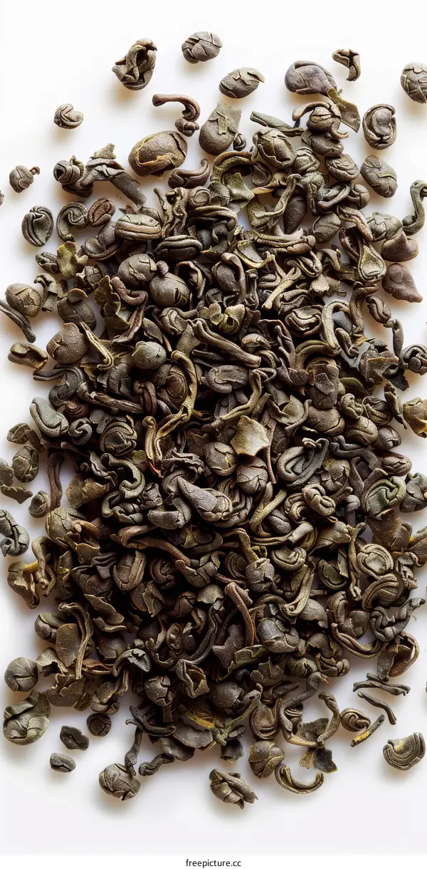 Green Tea Leaves Piled on White Surface