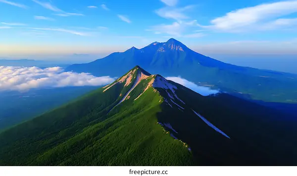 Majestic Mountain Range Under a Cloud-Kissed Sky