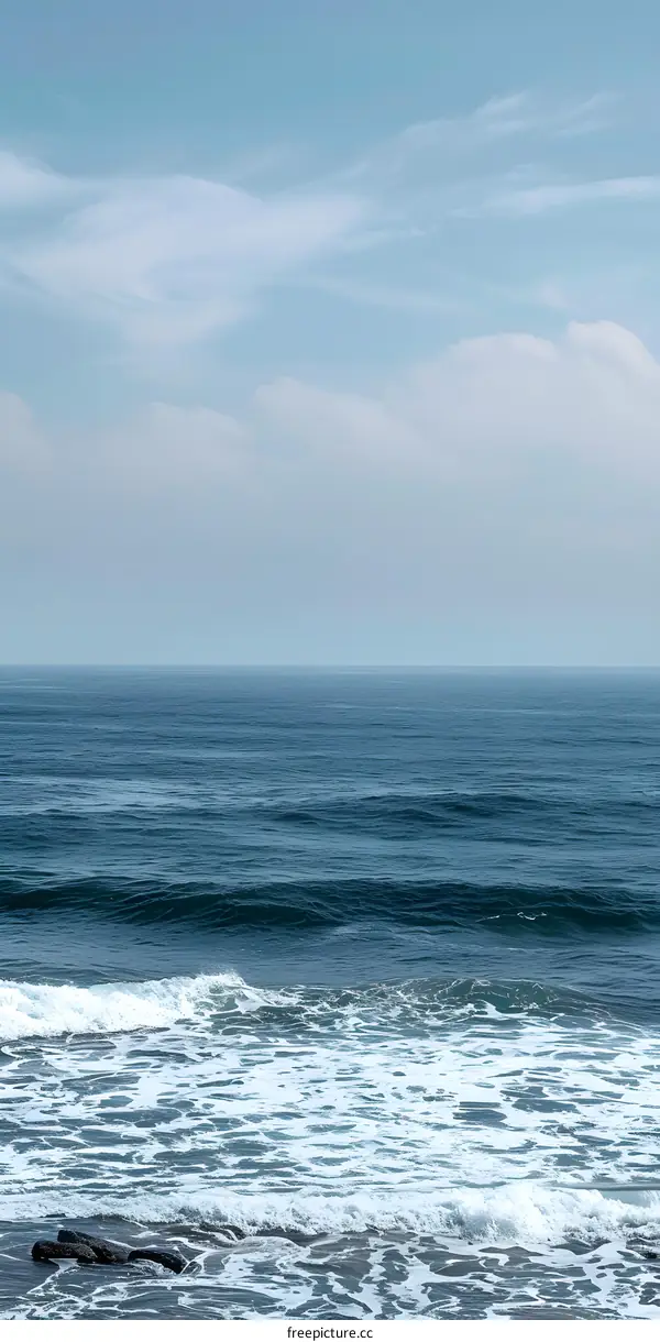 Blue Sky and Ocean Waves Crashing on the Shore
