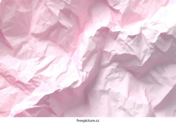 Close-up of crumpled pink paper texture background