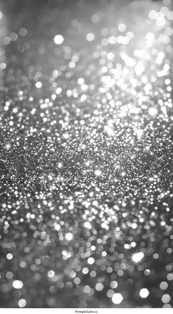 Silver glitter sparkles with a spotlight