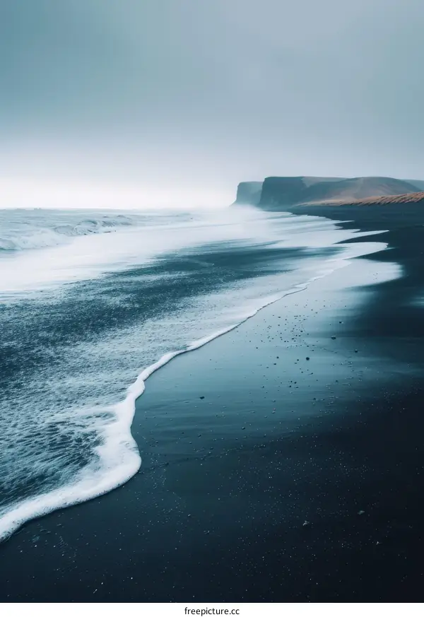 Black sand beach in Iceland with large waves crashing on the shore
