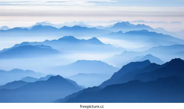Majestic Mountain Ranges in a Misty Blue
