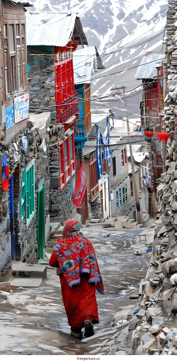 Woman Walking Through Narrow Street In A Mountain Village