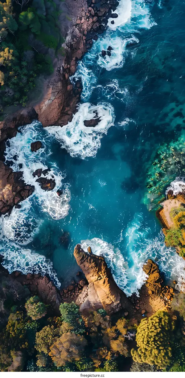 Aerial View of Ocean Waves Crashing on Rocky Coastline