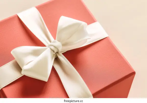 A red gift box with a white ribbon