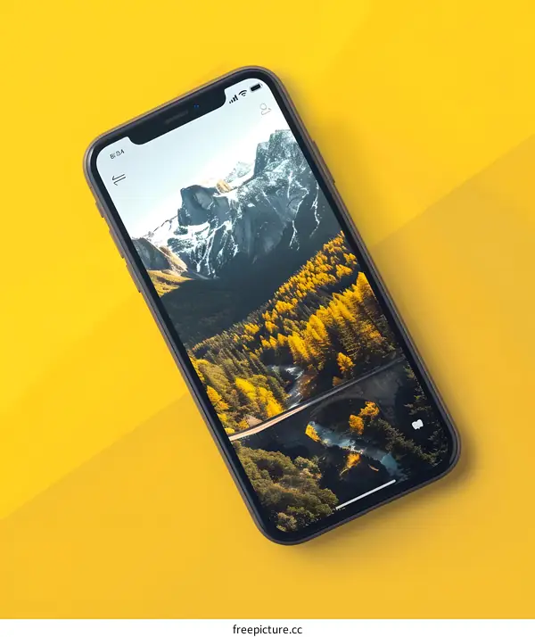 Smartphone with Mountain Landscape Wallpaper on Yellow Background