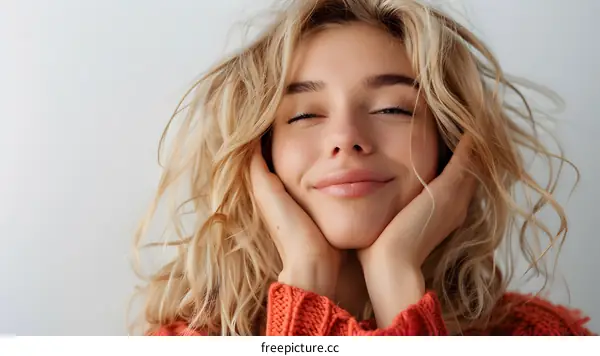 Portrait of a beautiful blonde woman smiling with her eyes closed