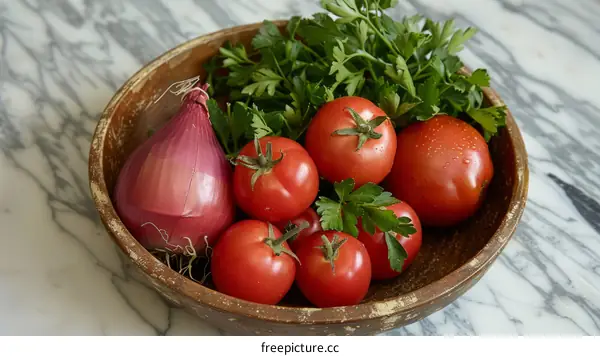 A bowl of tomatoes, onion and parsley