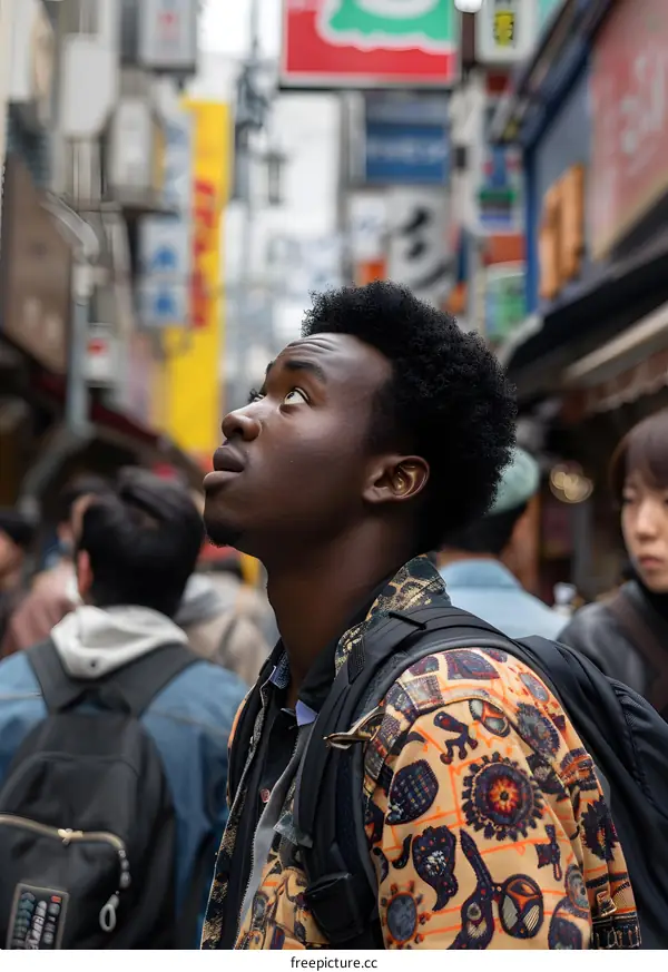 African Man Looking Up in Tokyo Street