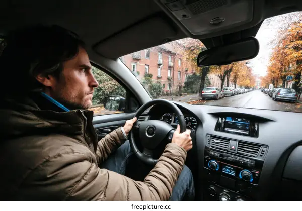 A Man Driving a Car in a European City