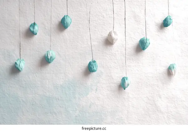 Handmade Paper Decorations Hanging on a Light Blue Background