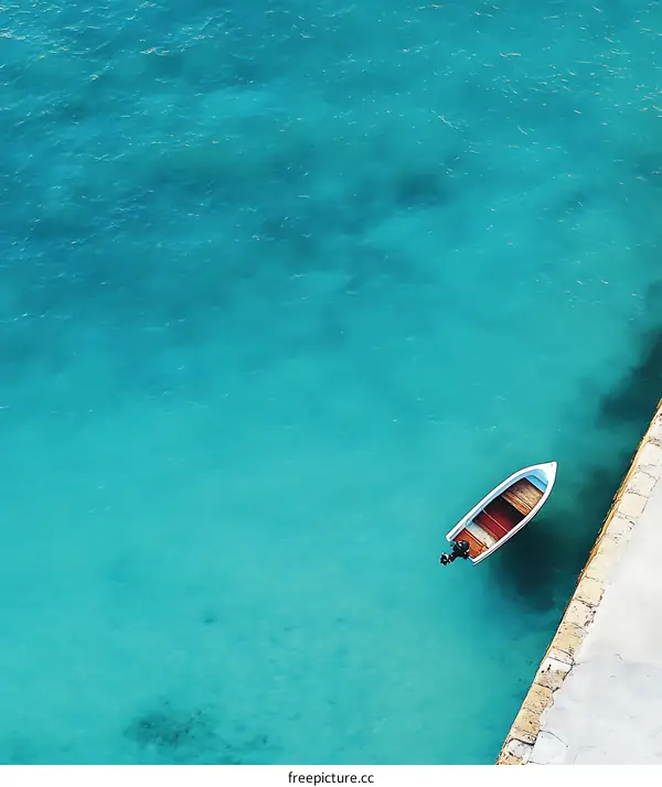 Aerial View of a Small Boat in Turquoise Water