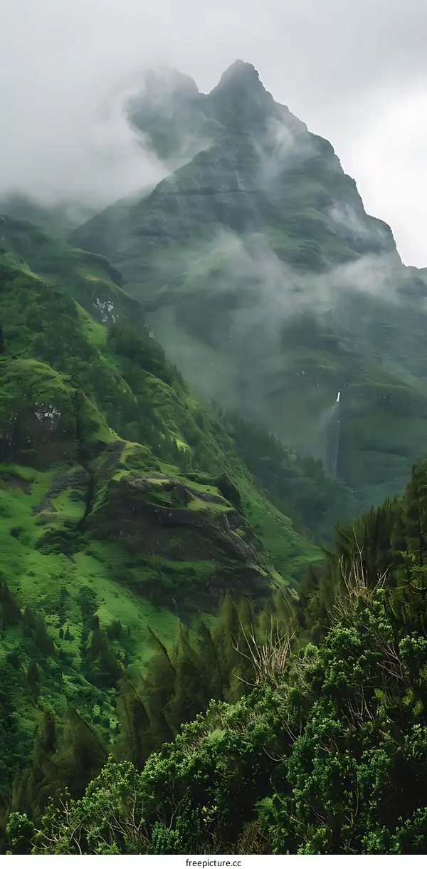 Green Mountains With Fog And Waterfall