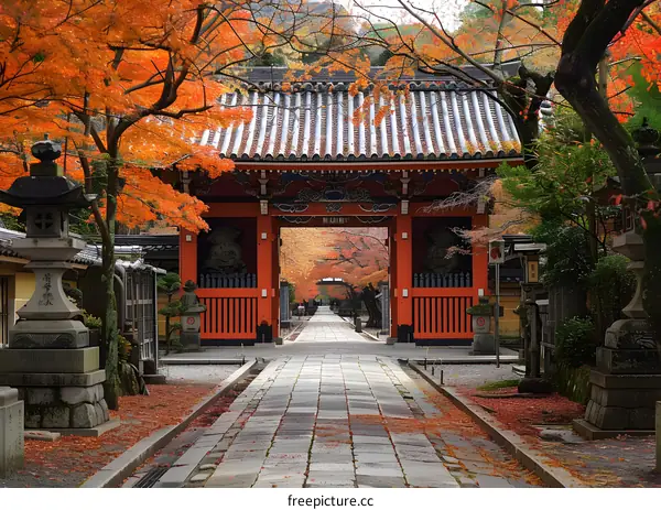 Pathway lined with red gates and maple trees in autumn