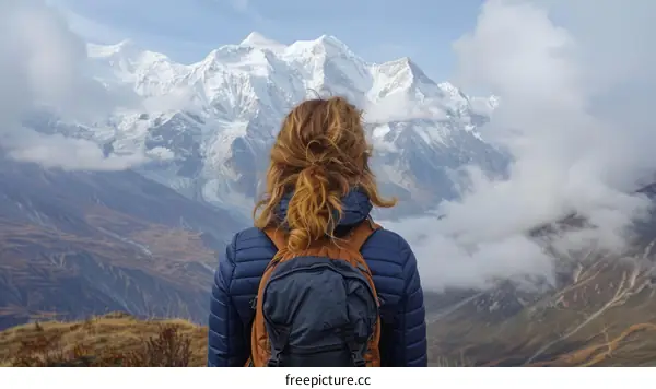 woman standing on a mountaintop looking at the view