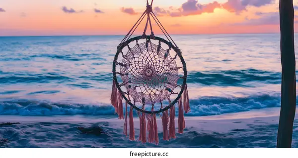 Dreamcatcher Hanging Over Ocean Beach at Sunset