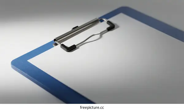 Close-up of a blue clipboard with white paper and metal clip