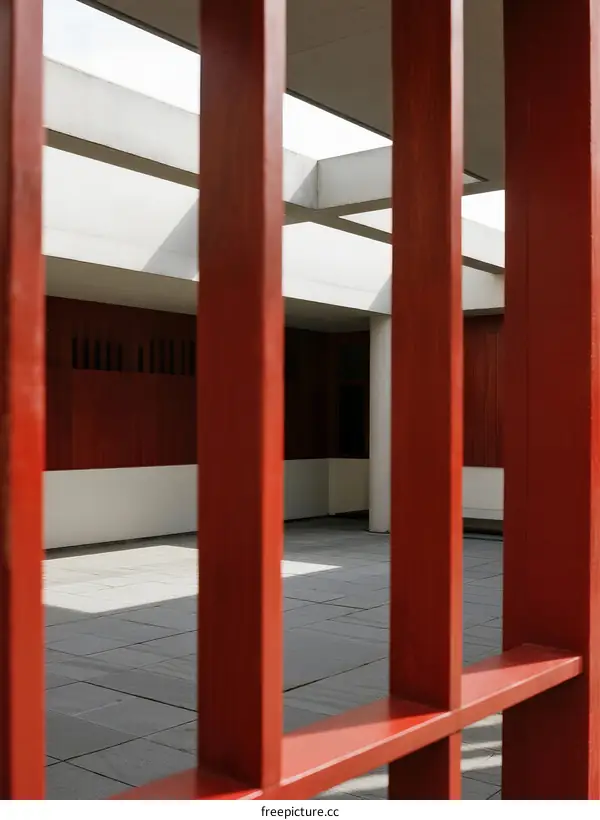Red wooden frame with white architectural structure in background