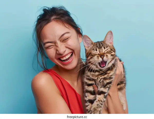 Laughing woman holding a cat