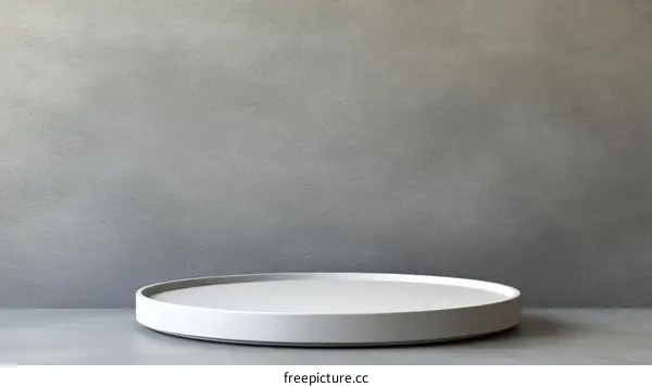 Empty White Pedestal Against Gray Concrete Wall