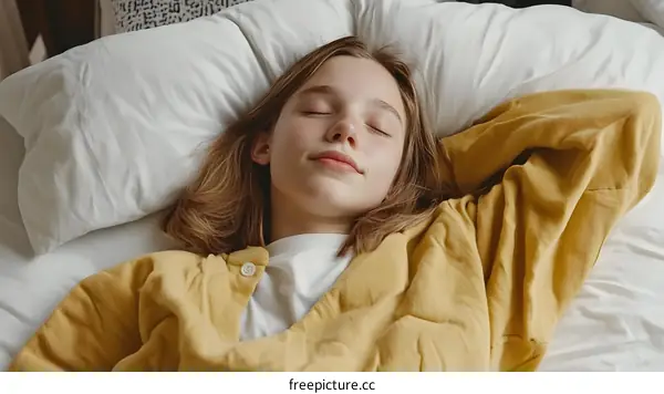 Young Woman Sleeping Peacefully In Bed