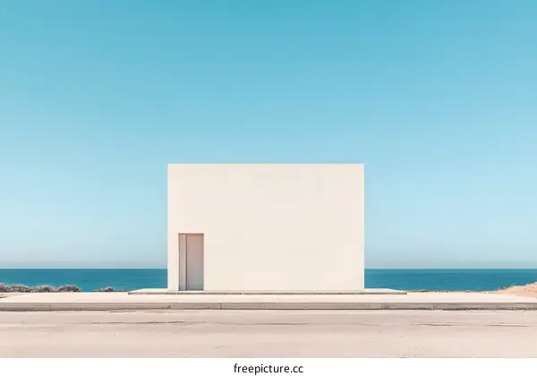 Minimalist White Building on Beach with Blue Sky