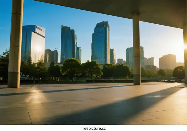 Sunlit modern city skyline with tall buildings and open space