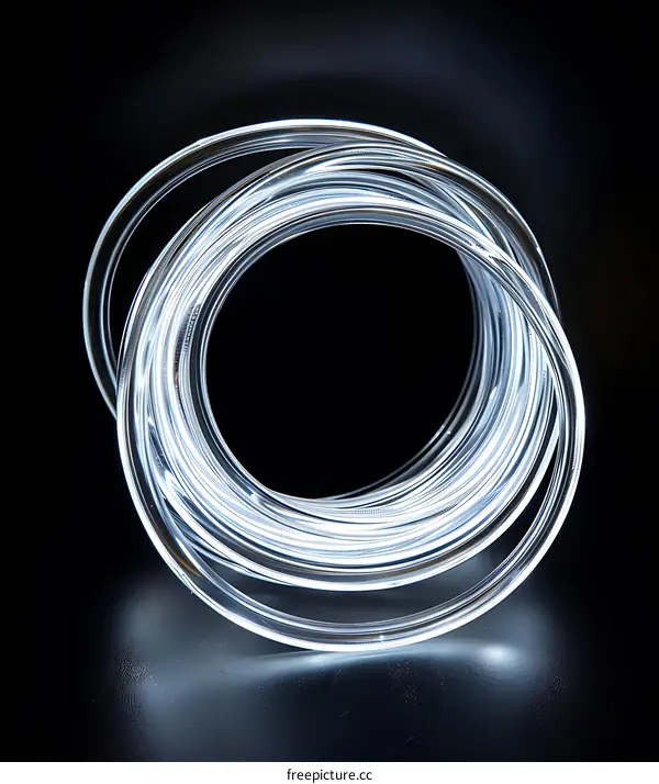 White Light String Coiled in Circle on Black Background