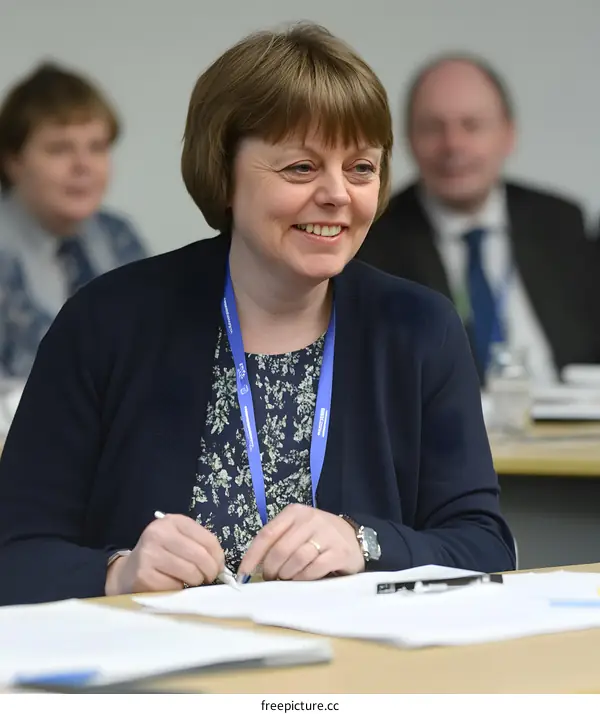 Businesswoman Sitting at a Table in a Conference Room