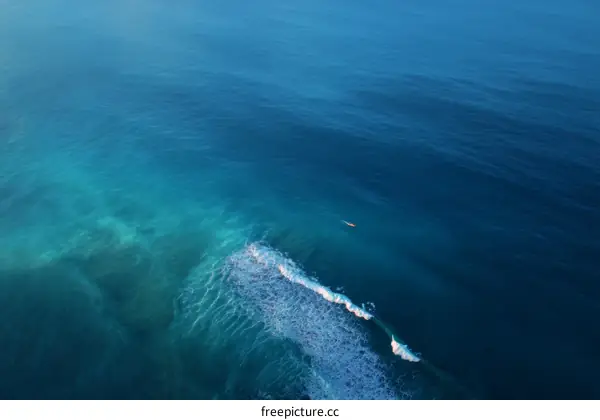 Aerial View of Ocean Waves and a Small Craft