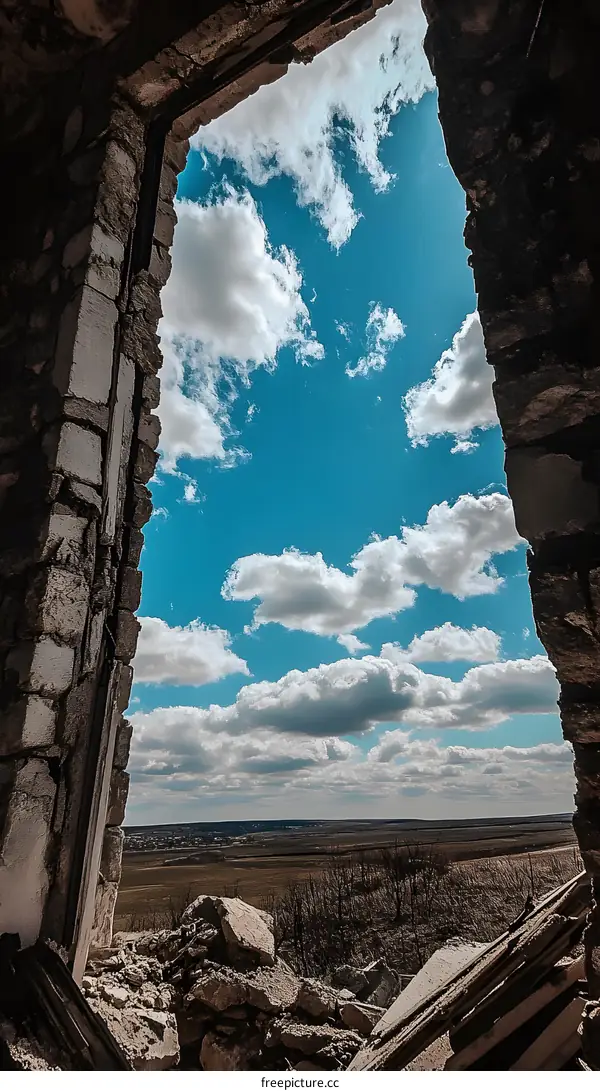 Broken Window View of Blue Sky and Clouds