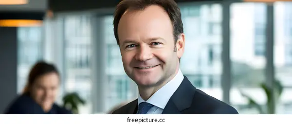 Portrait of a Smiling Man in a Suit in an Office Setting