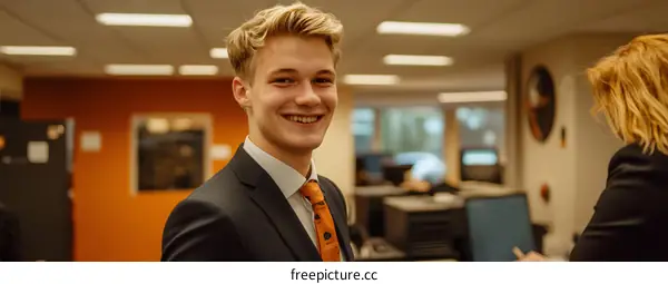 Smiling Young Man in Suit and Tie in Office Setting