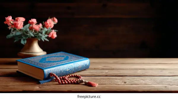 Holy Book on Wooden Table with Flowers and Prayer Beads